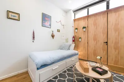 a small bedroom with a bed and a table at GuestReady - Bella's Downtown Apartment in Porto