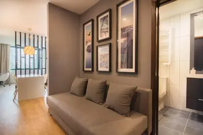a living room with a couch and some pictures on the wall at 447 Galé Apartment wifi, parking in Porto