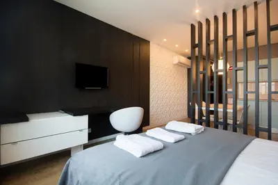 a bedroom with a bed with two pillows and a tv at 446 Galé Modern Apartment elevator,parking in Porto
