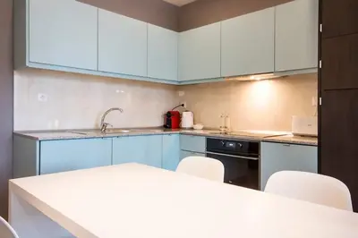 a kitchen with blue cabinets and white appliances at 446 Galé Modern Apartment elevator,parking in Porto
