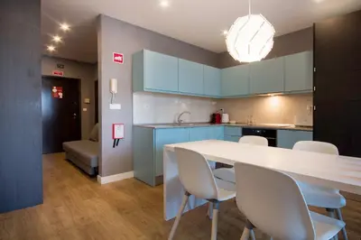 a kitchen with a white table and white chairs at 446 Galé Modern Apartment elevator,parking in Porto