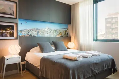 a bedroom with a bed with two towels on it at 446 Galé Modern Apartment elevator,parking in Porto