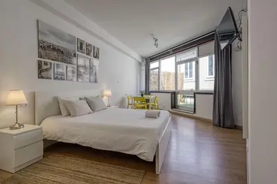 a bedroom with a bed and a large window at Travel & Live Aliados Apartment in Porto