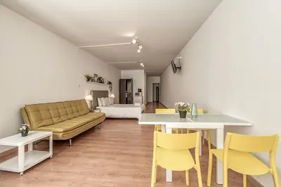 a living room with a couch and a table and chairs at Travel & Live Aliados Apartment in Porto