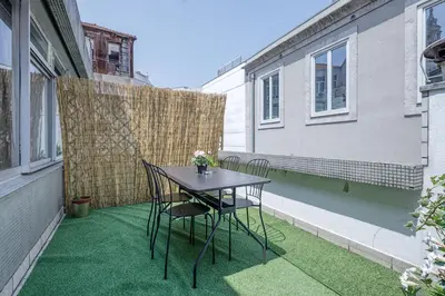 a small patio with a table and chairs on a balcony at Travel & Live Aliados Apartment in Porto