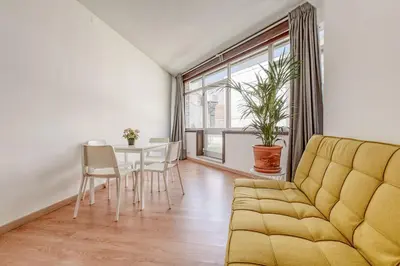 a living room with a couch and a table at Travel & Live Aliados Apartment in Porto