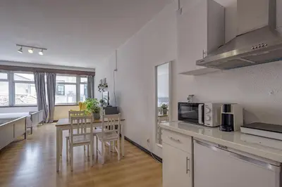 a kitchen and dining room with a table and a microwave at Travel & Live Aliados Apartment in Porto