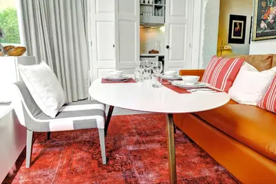 a living room with a table and a couch at Three Houses & Bedrooms in Porto