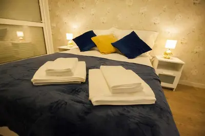 a bedroom with a bed with towels on it at Golden & Blue House, o seu novo espaço no Porto in Porto