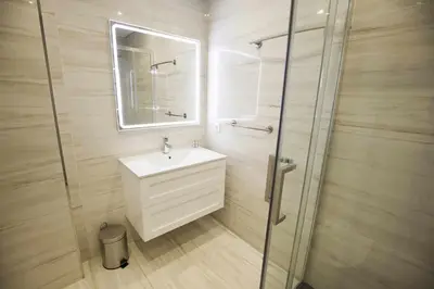 a bathroom with a sink and a glass shower at Golden & Blue House, o seu novo espaço no Porto in Porto