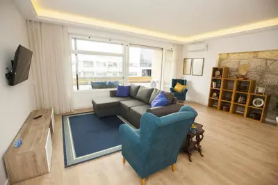 a living room with a couch and a blue chair at Golden & Blue House, o seu novo espaço no Porto in Porto