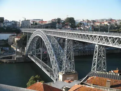 a large bridge over a river with a city at Golden & Blue House, o seu novo espaço no Porto in Porto