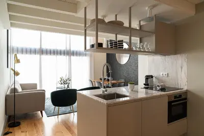 a kitchen with a sink and a living room at Shiny Porto in Porto