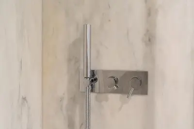 a shower with a shower head on a wall at Shiny Porto in Porto