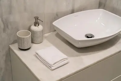 a white sink and towels on a counter in a bathroom at Shiny Porto in Porto