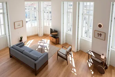 a living room with a couch and chairs and windows at Tripas-Coração, Santa Catarina in Porto
