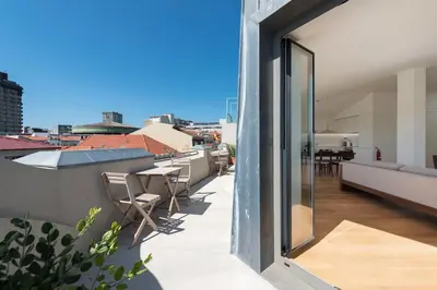 a balcony with chairs and a view of a city at Tripas-Coração, Santa Catarina in Porto
