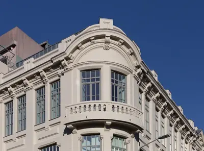 a white building with a balcony on top of it at Tripas-Coração, Santa Catarina in Porto