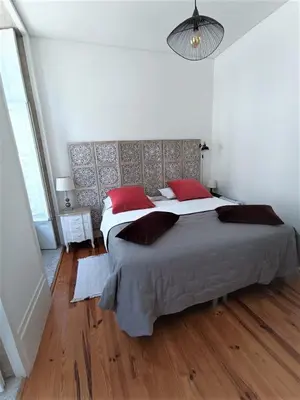 a bedroom with two beds with red pillows at Appartement Pont Luiz in Porto