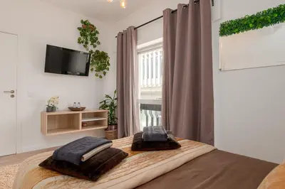 a bedroom with a bed with two pillows on it at Avenue View Rooms - Guest House in Porto
