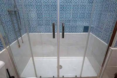 a kitchen with white cabinets and a sink at Avenue View Rooms - Guest House in Porto