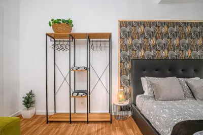 a bedroom with a bed and a wall at Avenue View Rooms - Guest House in Porto