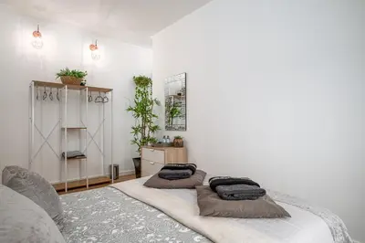 a living room with a tv on a wall at Avenue View Rooms - Guest House in Porto