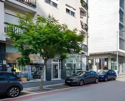 an empty street with cars parked on the side of the road at Avenue View Rooms - Guest House in Porto