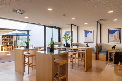 a living room with a couch and a table at BFRESH Hotel - Padel, Pool & Fitness - Adults Only in Porto