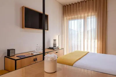 a hotel room with a bed and a kitchen at BFRESH Hotel - Padel, Pool & Fitness - Adults Only in Porto