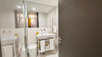 a white bathroom with a shower and a sink at Domus 21 - Batalha in Porto