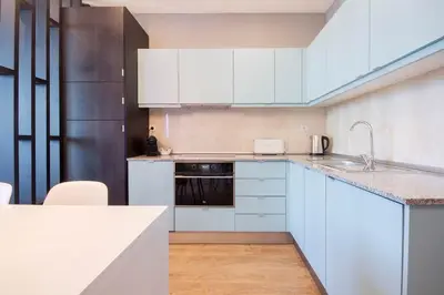 a white kitchen with white cabinets and a sink at 418 Apartamento Galé wifi, estacionamento, elevador in Porto