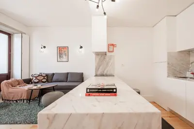 a kitchen with a marble counter top in a living room at Oporto Shine in Porto