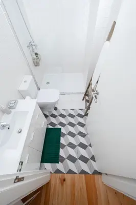 a bathroom with a white sink and a toilet at Oporto Shine in Porto