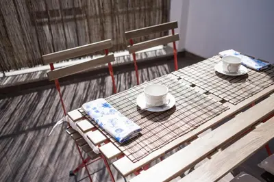 a picnic table with two cups and saucers on it at Oporto Shine in Porto