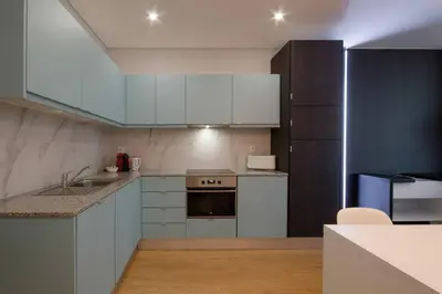 a kitchen with white cabinets and a sink at 406 Galé Center Apartment wifi, parking in Porto