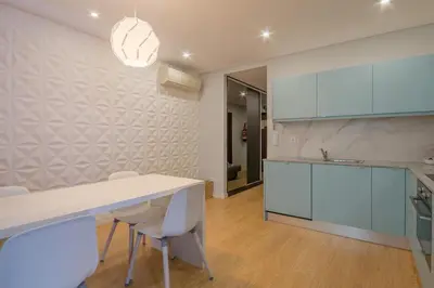 a kitchen with a white table and white chairs at 406 Galé Center Apartment wifi, parking in Porto
