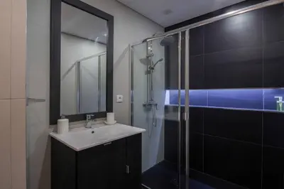 a bathroom with a sink and a glass shower at 406 Galé Center Apartment wifi, parking in Porto