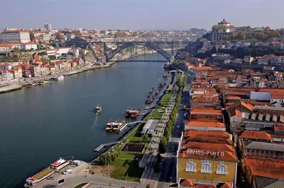a view of a river with a bridge and a city at Cais de Gaia Historic Loft in Vila Nova de Gaia