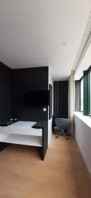 a bedroom with a bed and a desk and a chair at 404 Galé Center Apartment wifi, parking in Porto