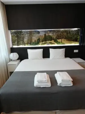 a bedroom with a large bed with two towels on it at 404 Galé Center Apartment wifi, parking in Porto