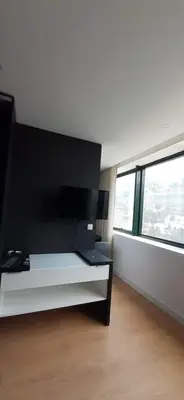 a bedroom with a black and white bed and windows at 404 Galé Center Apartment wifi, parking in Porto