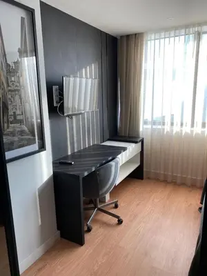 a desk with a chair in a room with a window at 411 Galé Center Apartamento Wi-Fi, estacionamento in Porto