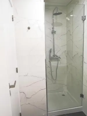 a bathroom with a shower with a glass door at OportoView Prestige Apartment in Porto