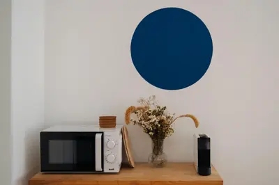 a microwave on a wooden table with a vase of flowers at Oxford Green House by LovelyStay in Porto