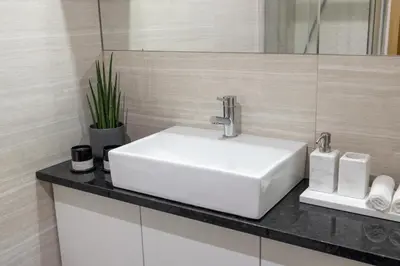a white sink sitting on a counter in a bathroom at Box Market Square Apartment in Porto