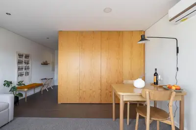 a living room with a table and chairs and a couch at Box Market Square Apartment in Porto