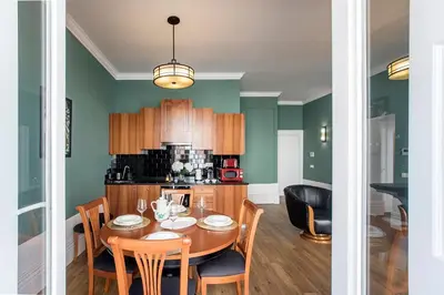 a kitchen and dining room with a table and chairs at Artistic 2BR Flat Downtown w/ AC by LovelyStay in Porto