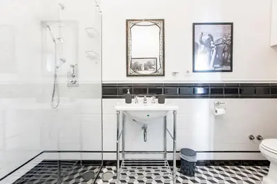 a white bathroom with a sink and a shower at Artistic 2BR Flat Downtown w/ AC by LovelyStay in Porto