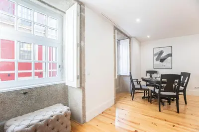 a dining room with a table and chairs at Elegant Downtown 1BR Flat w/ AC by LovelyStay in Porto